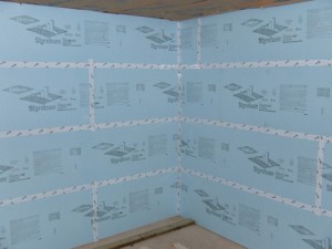 Picture of foam board sealed with Tyvek tape in a basement.